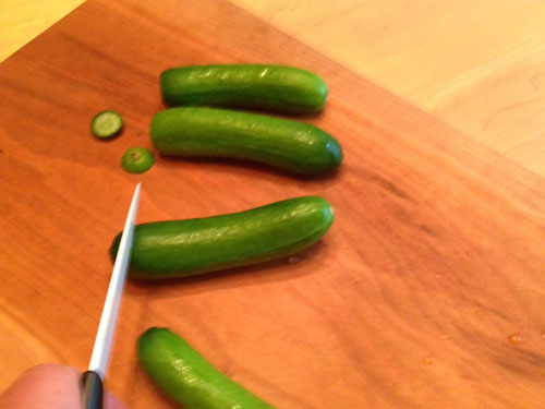 blossom-ends of cucumbers being cut off